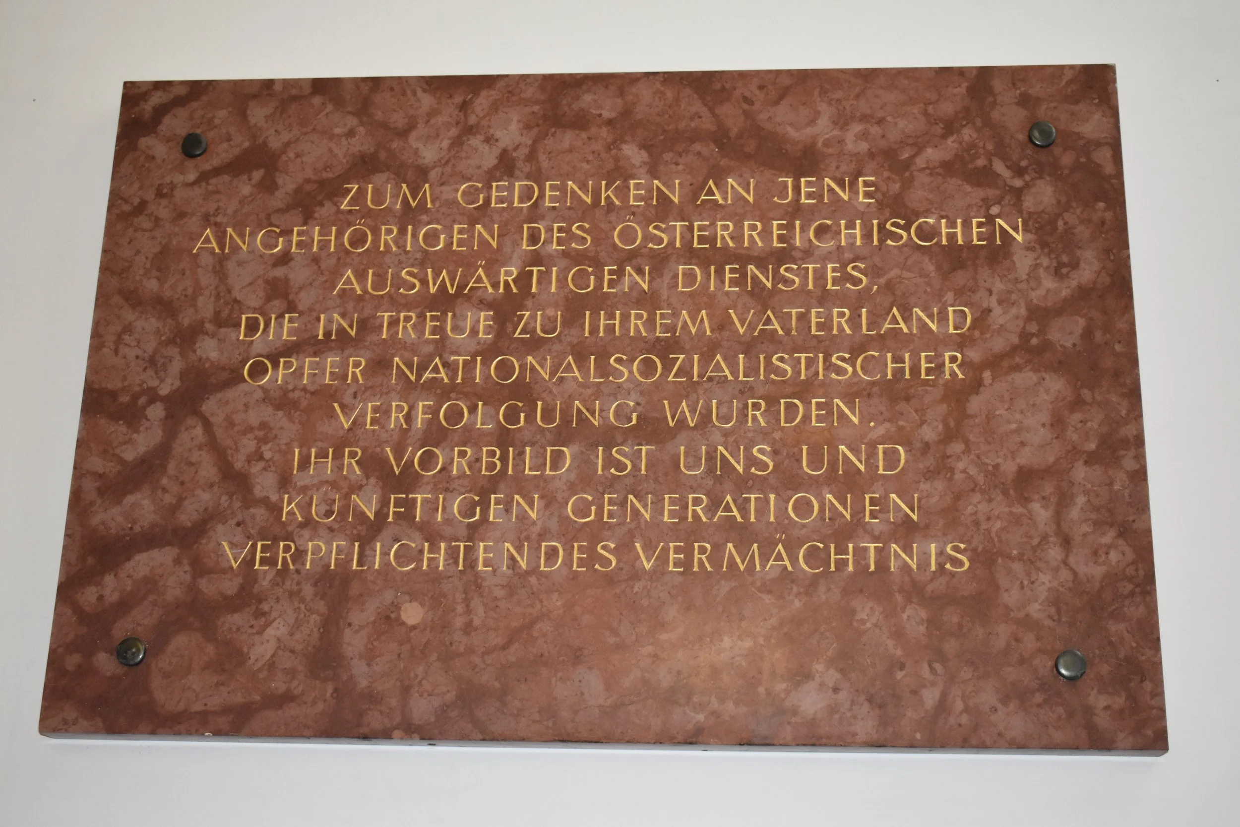 A plaque bears witness to atrocities committed against members of the foreign service. Photo by Molly McCluskey.
