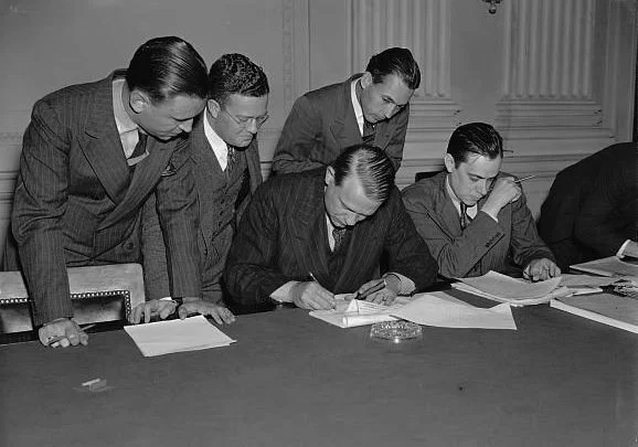 Chairman Dies of the House Un-American Activities Committee, pens a letter to President Roosevelt while newspapermen look on. Photo courtesy of the Library of Congress.