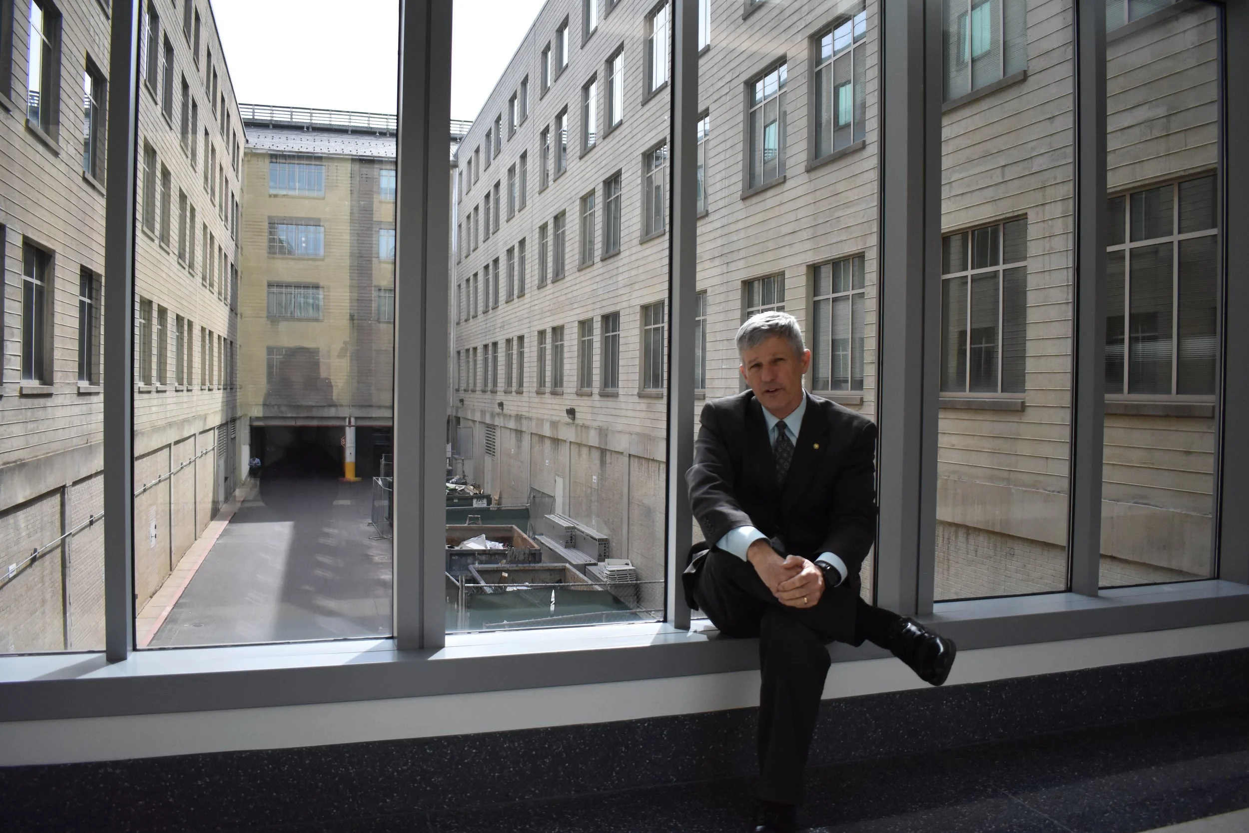 Army Engagement Officer Randy Odom sits in the corridor where AA flight 757 flew into the Pentagon. Photo by Diplomatica Global Media.