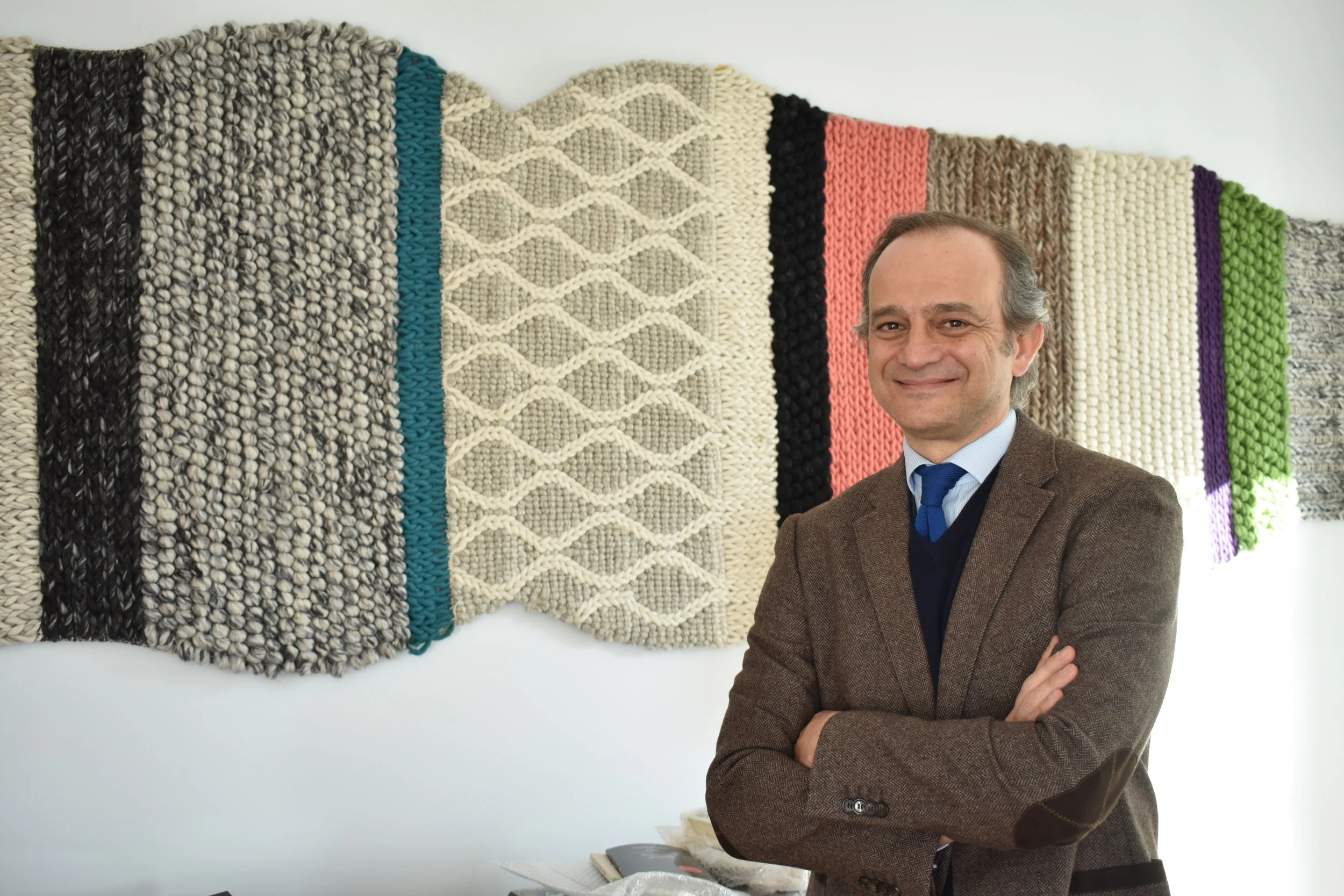 Migel Albero, head of Spain's Cultural Office, stands next to his favorite item in the Spanish Office Showroom.