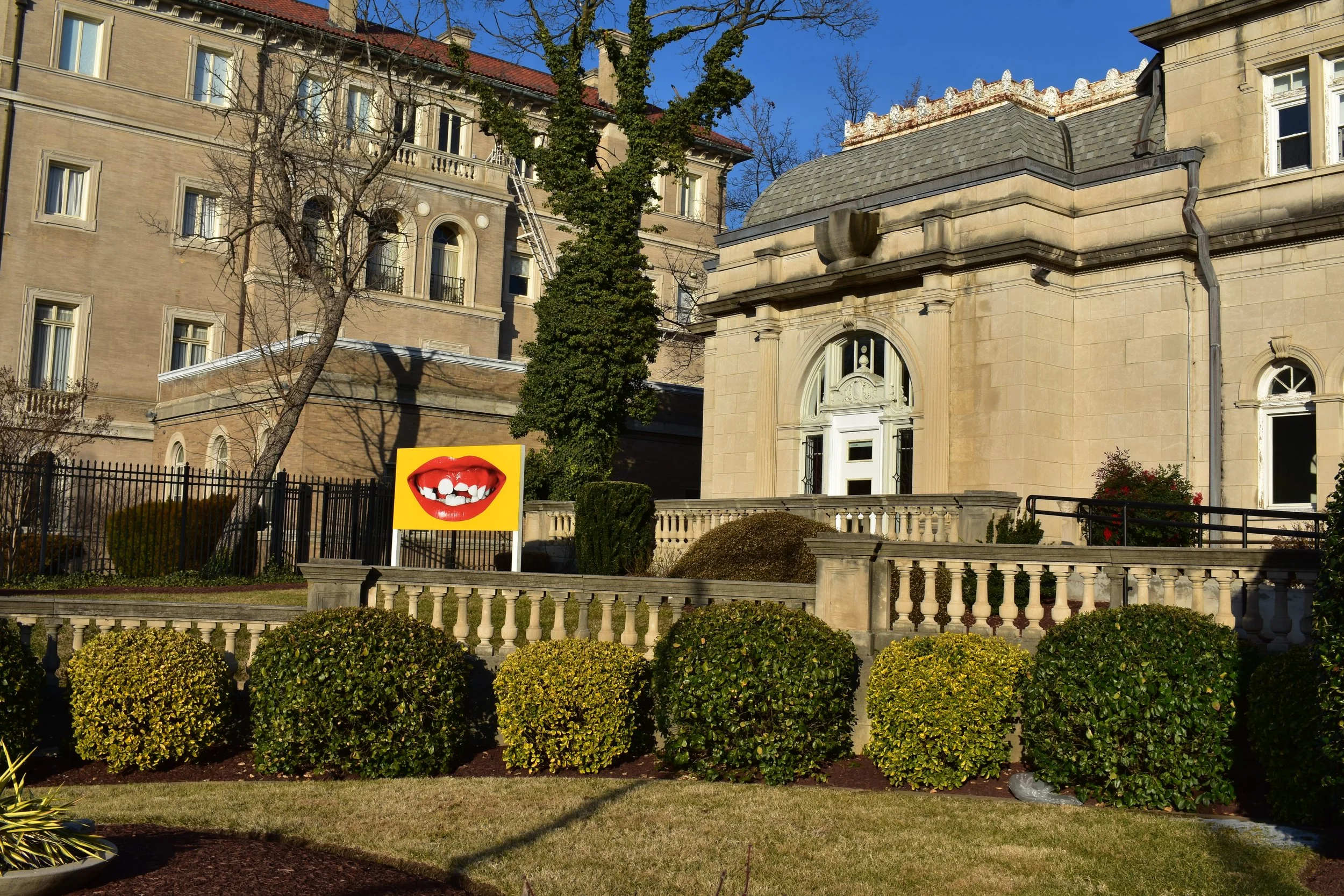 Rotating artwork inspired by the building's façade grace the front lawn.