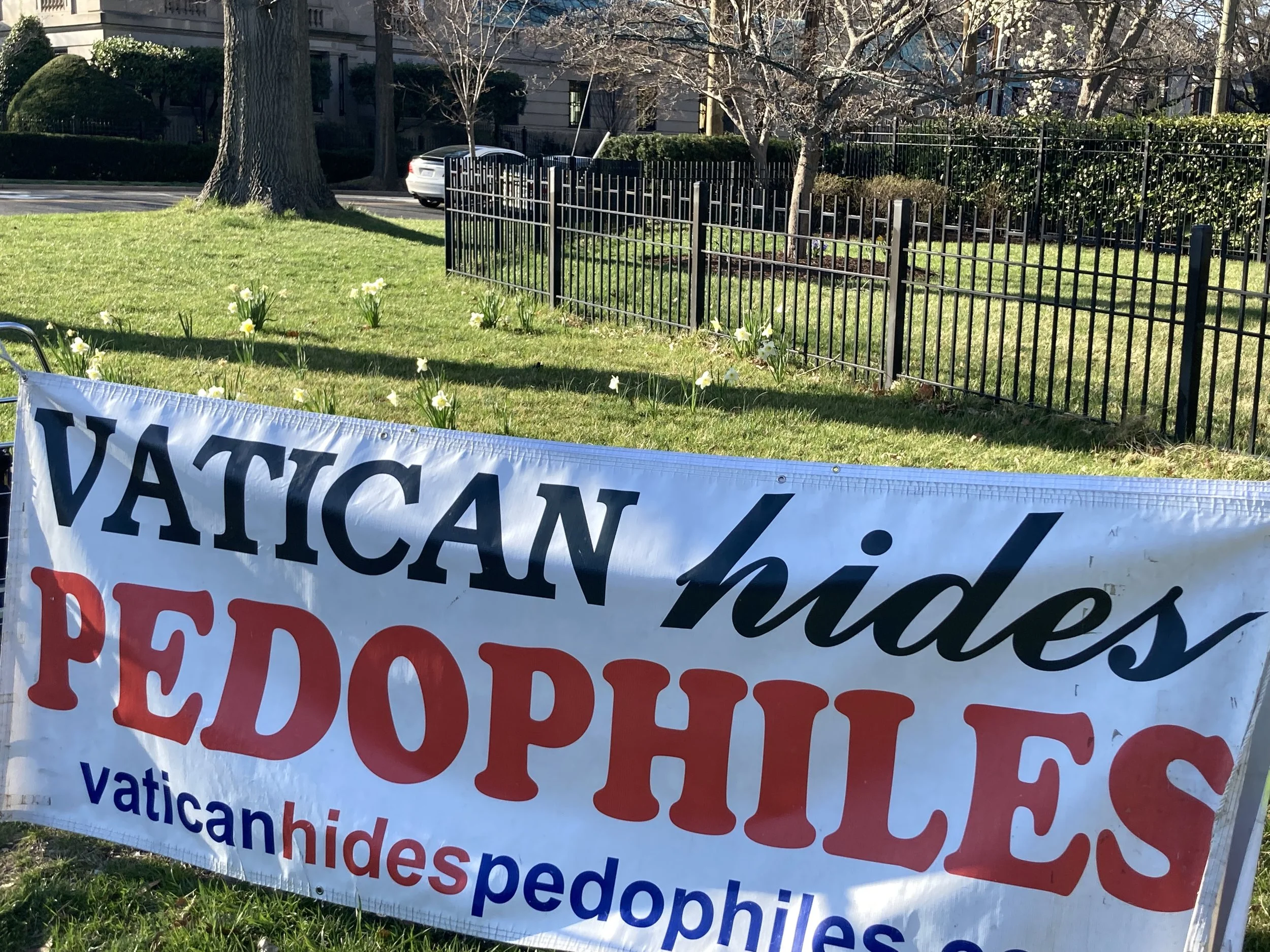 One of the banners that accompanies John Wojnowski's protests. Photo by Molly McCluskey.