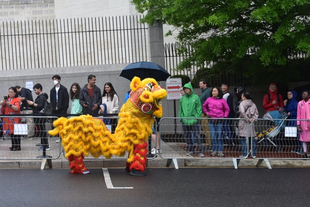 Dancers entertain the line outside the Embassy of China in 2024. Photo by Molly McCluskey for Diplomatica Global Media.